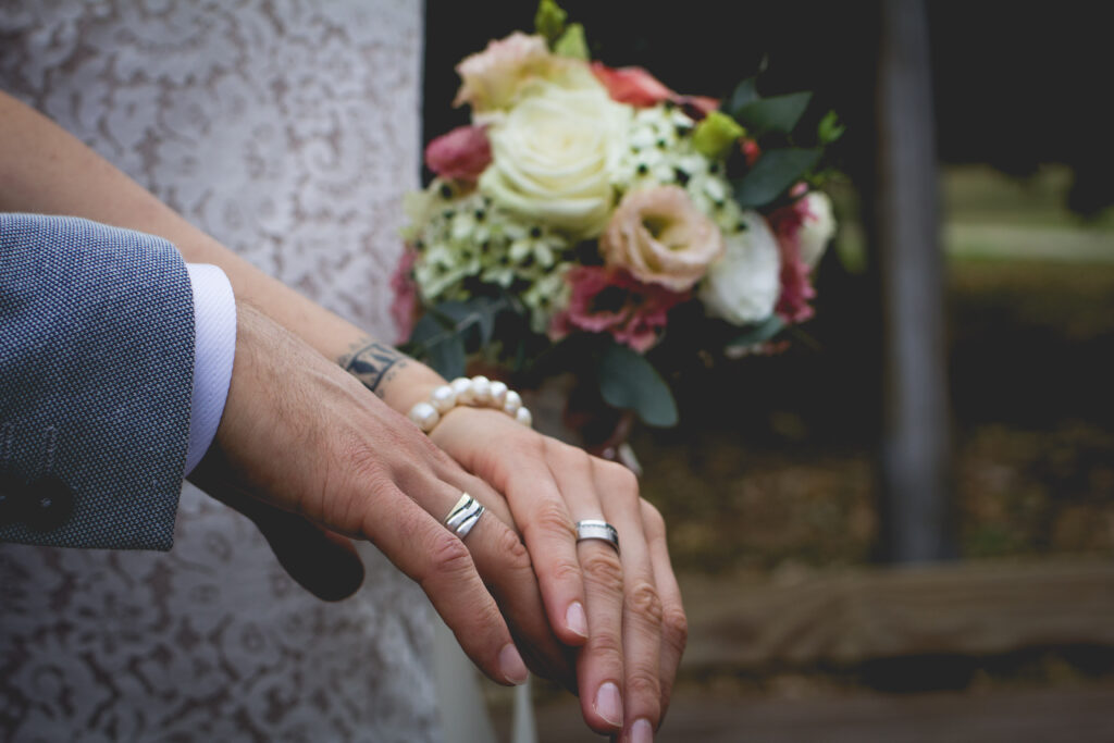 Newlyweds holding hands.